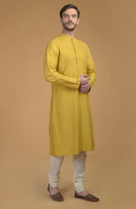 On Her: Mango Mojito Gota Patti & Zari Anarkali Set | On Him: Sunglow Yellow Pintuck Kurta & Mustard Waistcoat Jacket Set