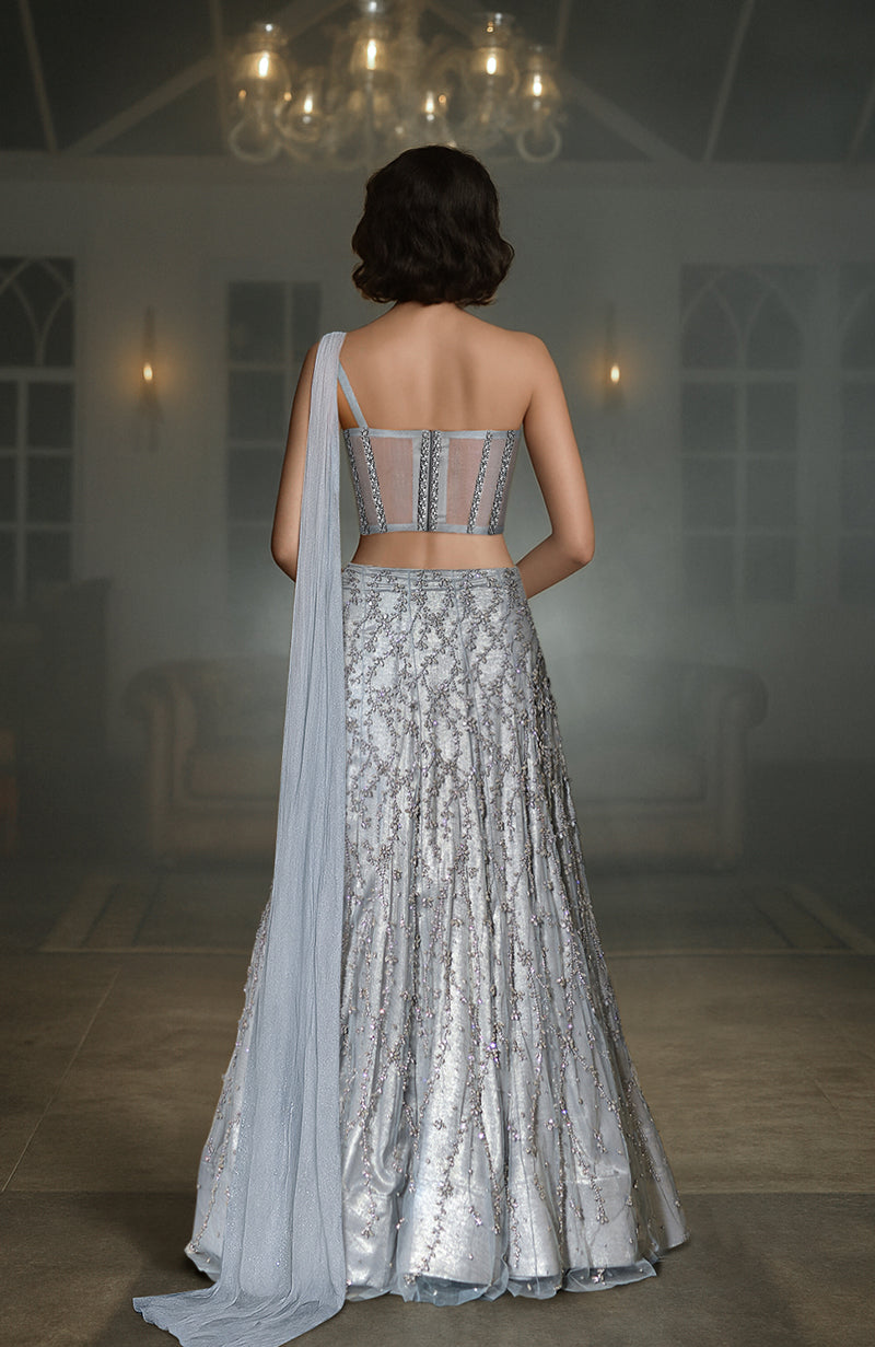 Silver grey hand-embroidered corset lehenga with a one-shoulder drape.
