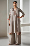 Taupe beige embroidered kurta set with wide-leg trousers and sheer dupatta.
