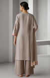 Taupe beige embroidered kurta set with wide-leg trousers and sheer dupatta.