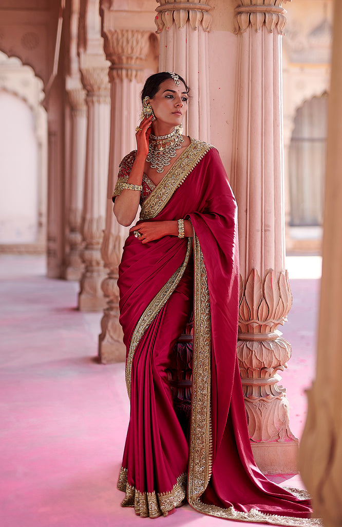 Blood red pure silk saree with gold zardozi embroidery.