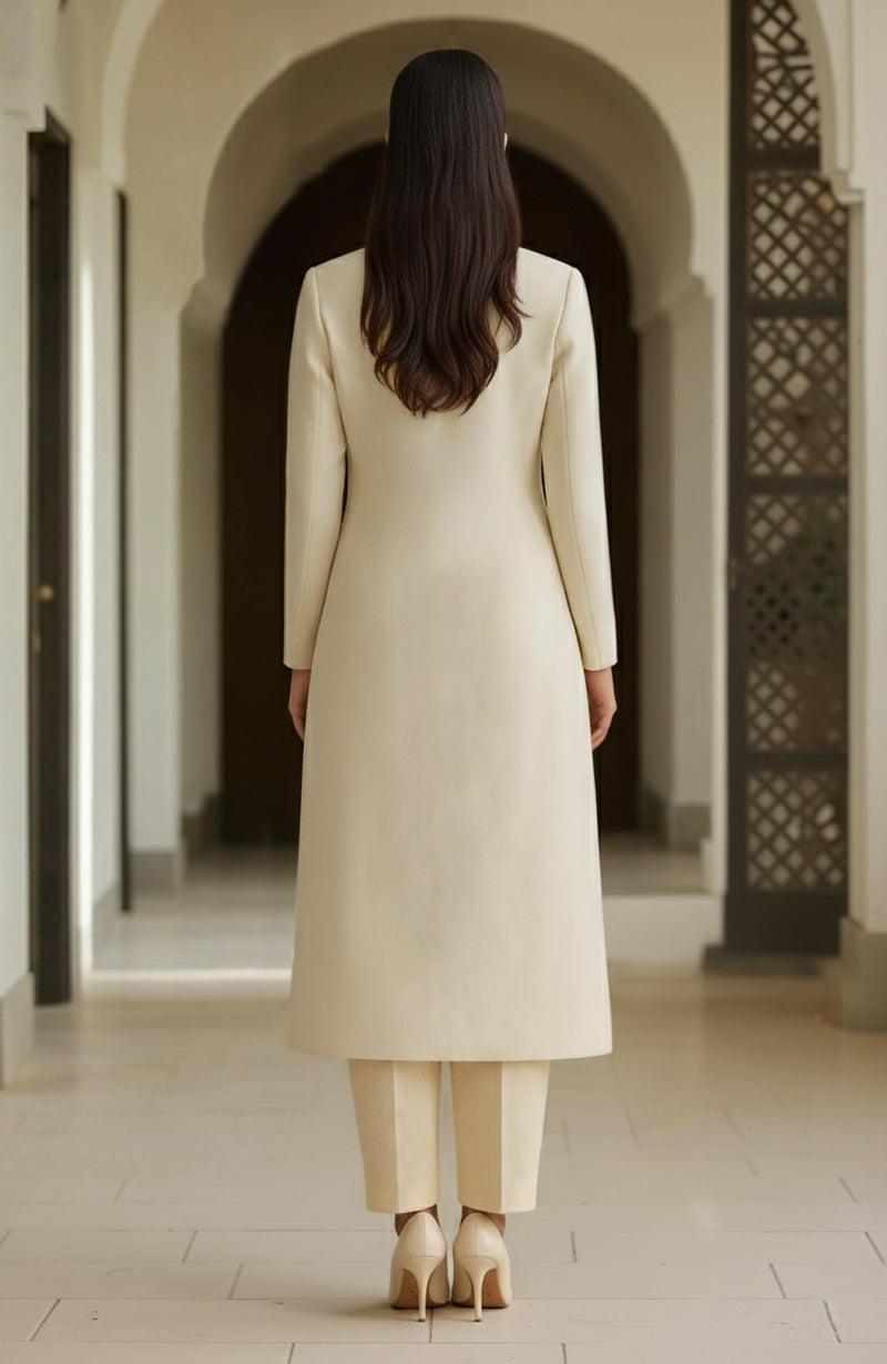 Ivory long-line kurta with straight trousers.