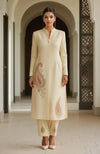 Ivory long-line kurta with embroidered paisleys and straight trousers.