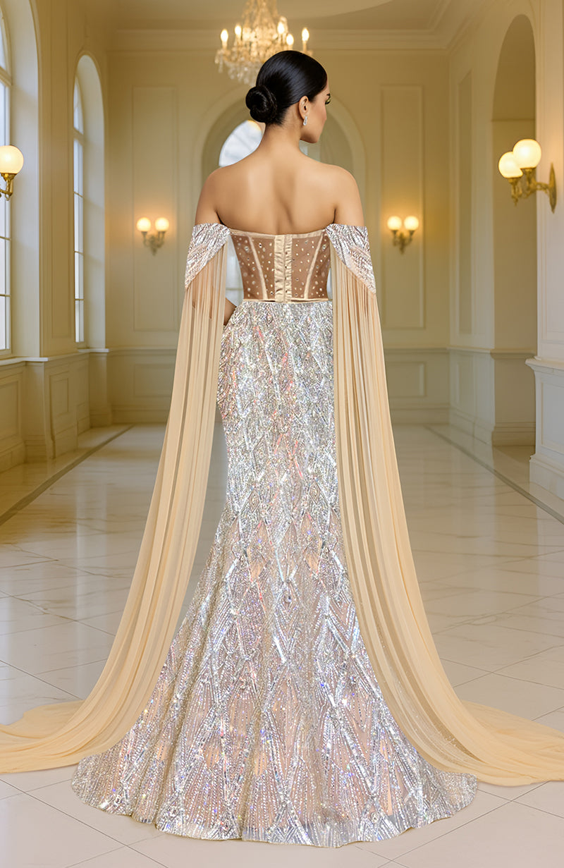 Silver champagne mermaid lehenga with a cape and intricate embellishments.